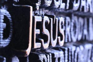 The name of Jesus carved in wood